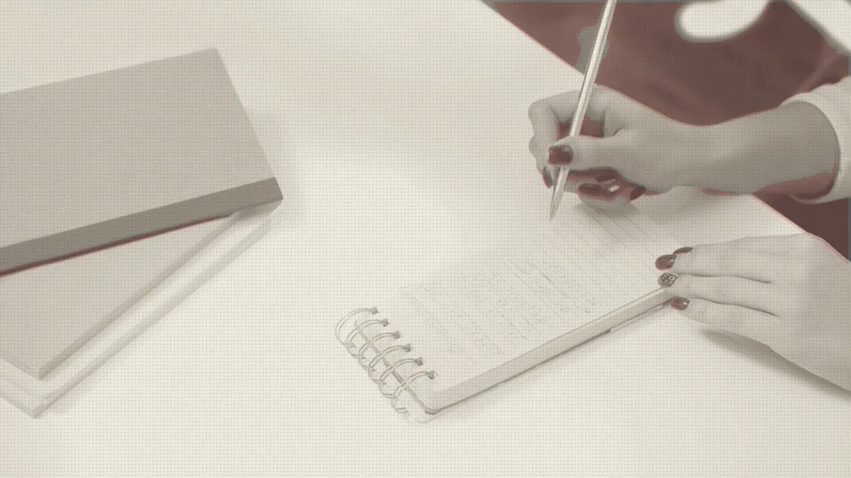 A writing desk with a notebook